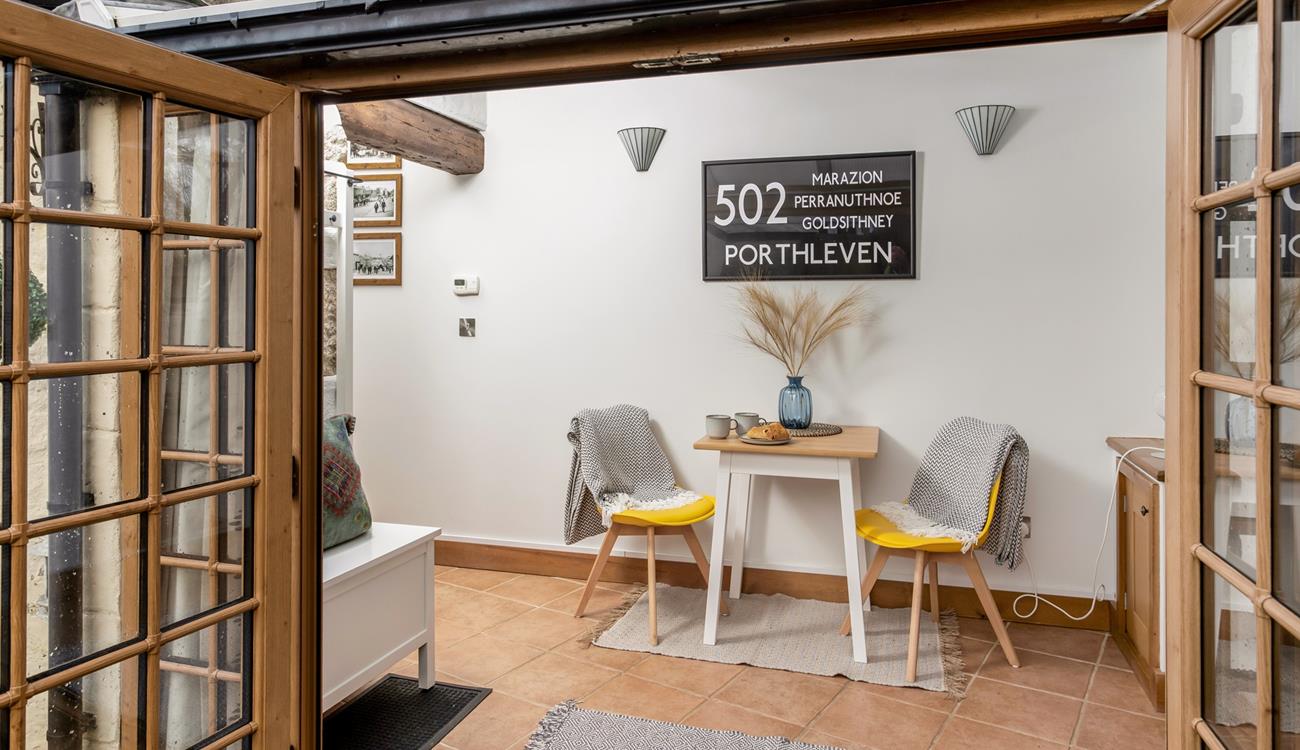 The sunroom offers space for a peaceful morning coffee.