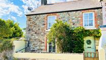 This delightful cottage is filled with charm for the perfect escape.