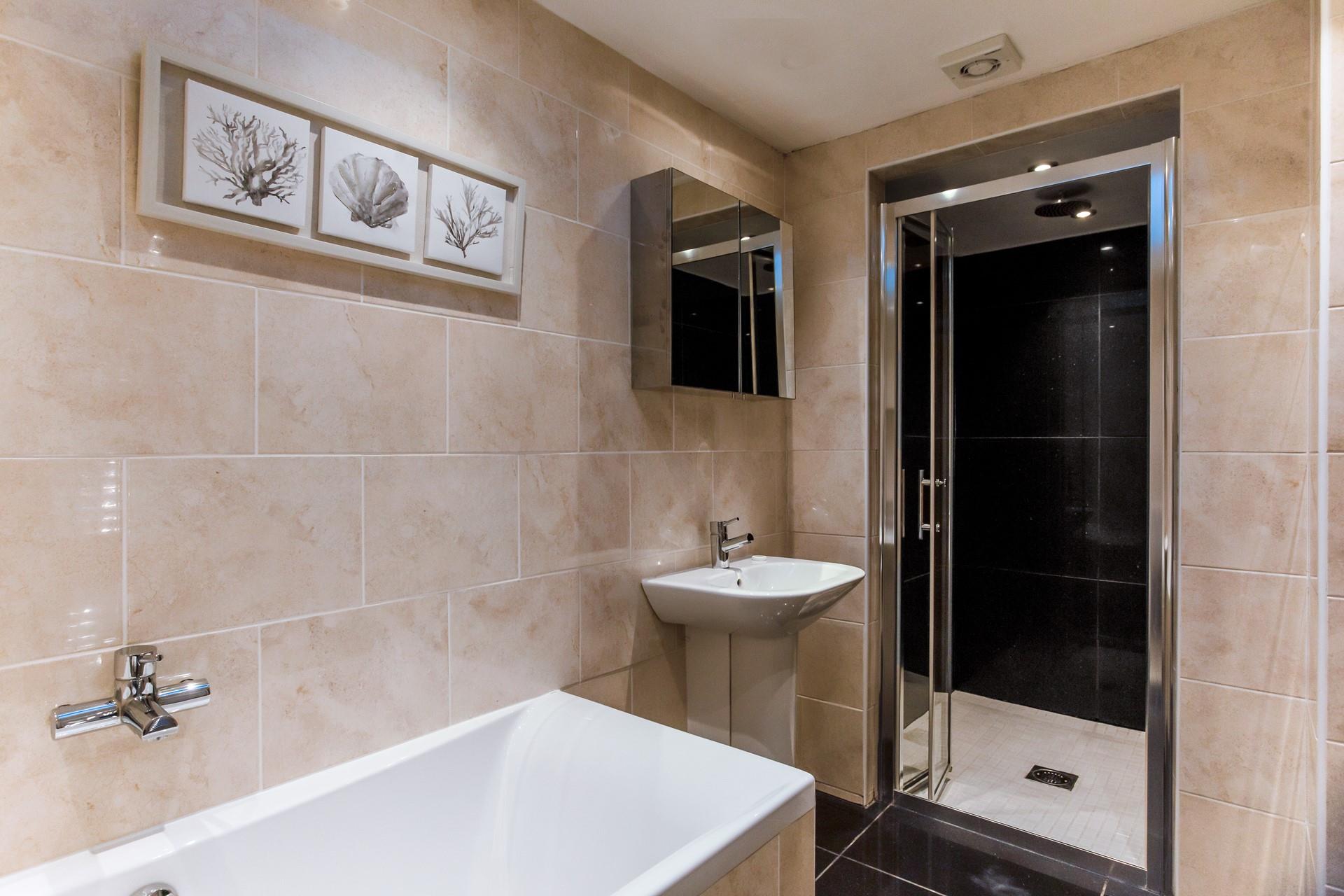 The bathroom has a walk-in shower and bathtub for washing sandy toes and indulging in pure relaxation.