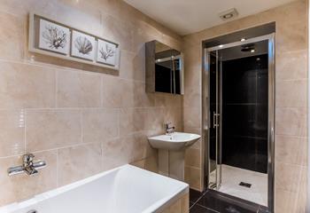 The bathroom has a walk-in shower and bathtub for washing sandy toes and indulging in pure relaxation.