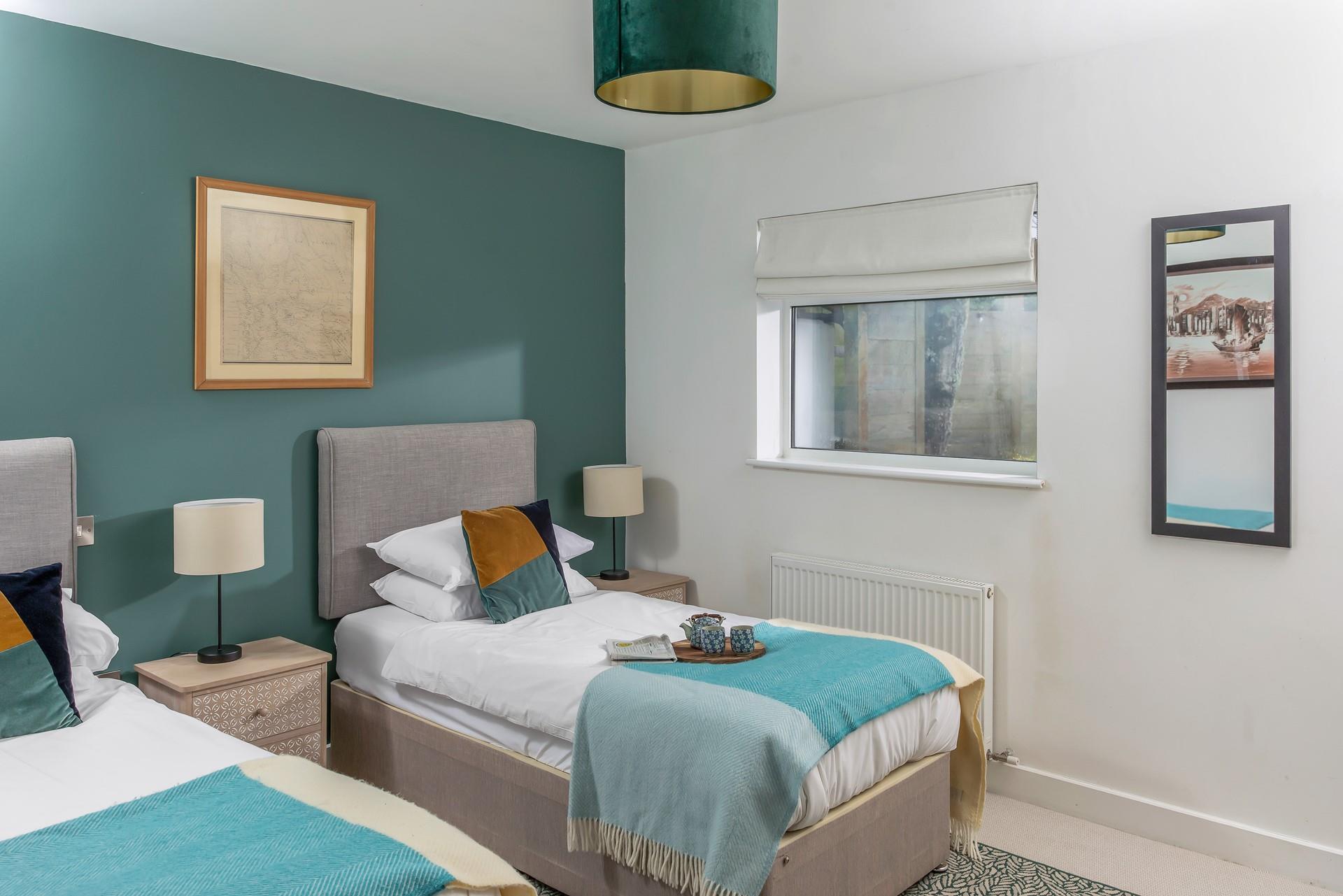 Deep greens and blues make this bedroom a cosy space to unwind each night.