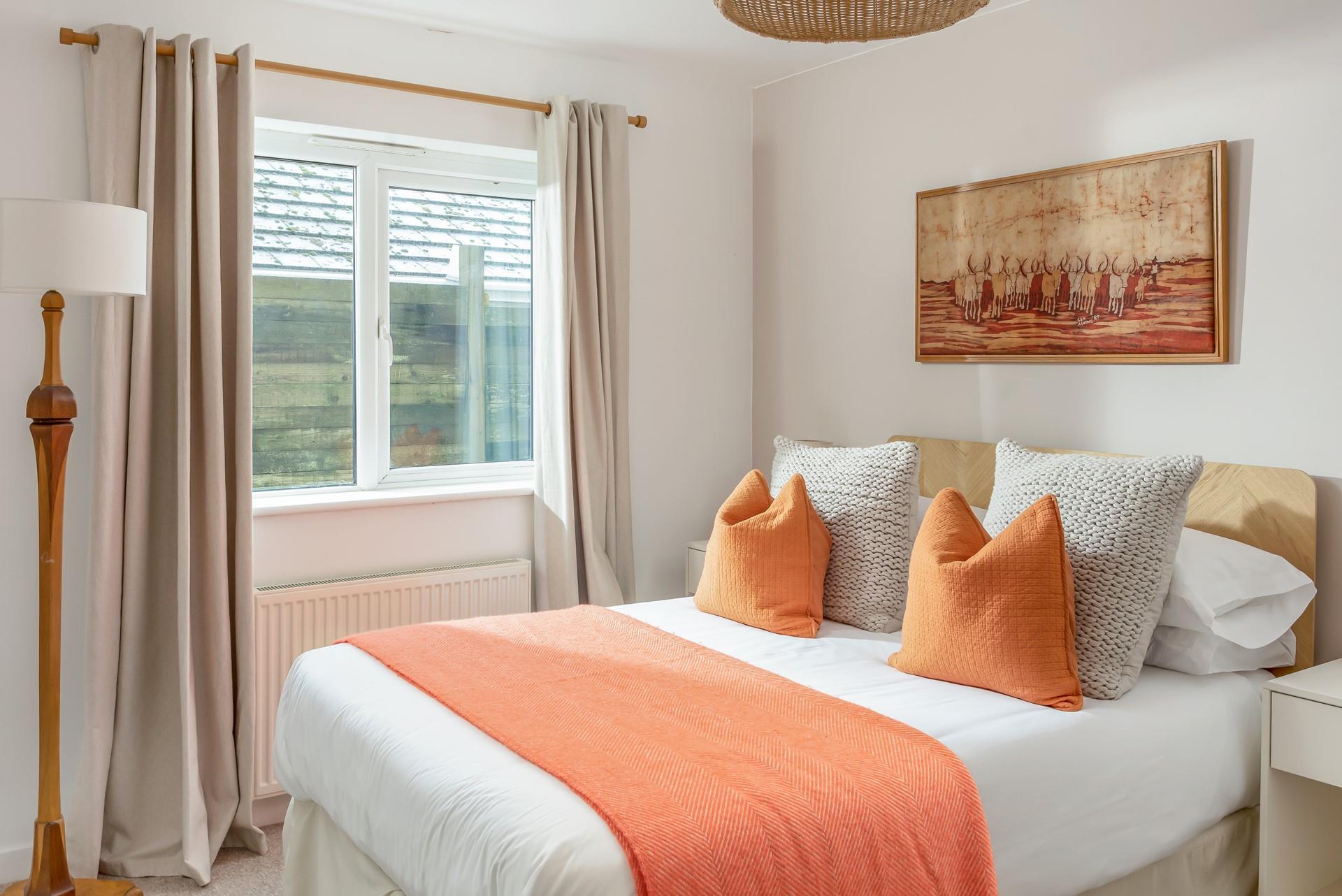 Bright orange colours in bedroom 2 make this a delightful bedroom to wake up in every morning.
