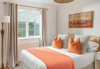 Bright orange colours in bedroom 2 make this a delightful bedroom to wake up in every morning.