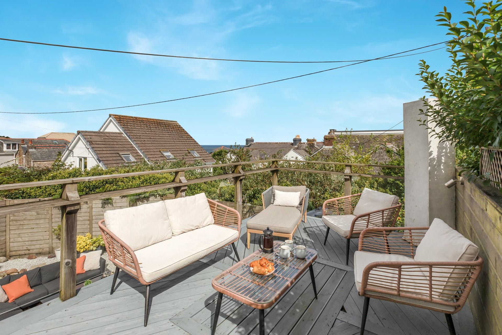 The balcony has stylish rattan furniture to relax and unwind in the evening.