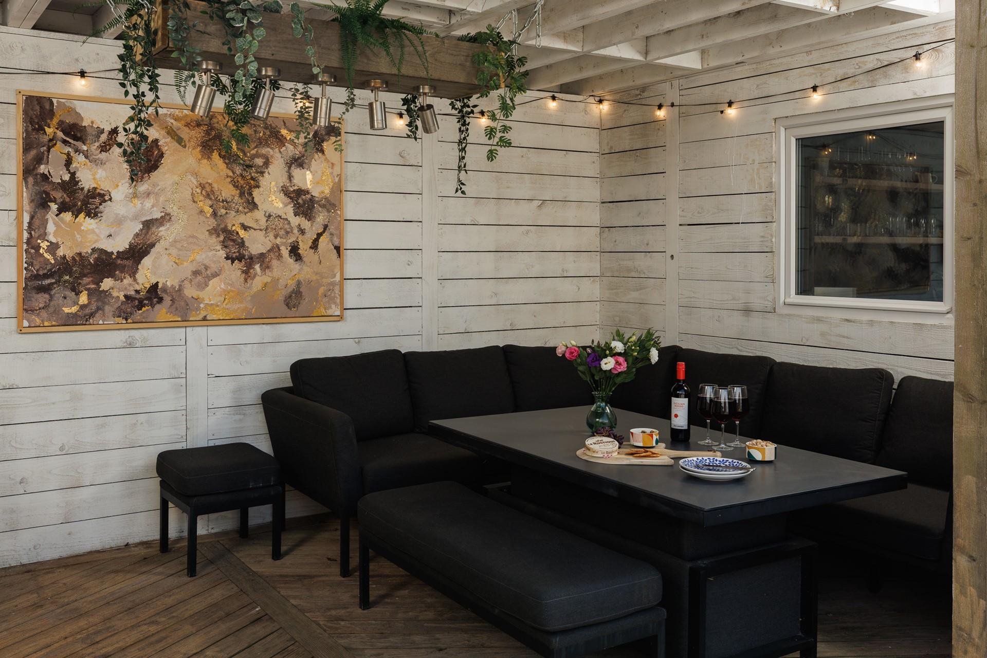 This cosy undercover corner of the garden is perfect for long evenings spent with a glass in hand.