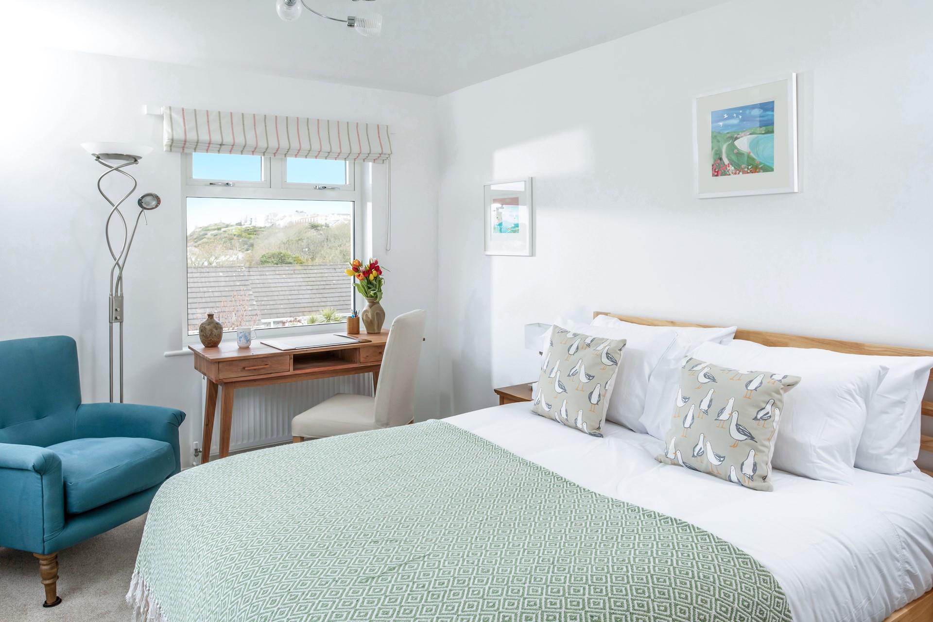 Bedroom 4 has a spacious king size bed and beautiful sea views.