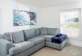 The sitting room is decorated with wonderful shades of blue to reflect the close proximity to the ocean.