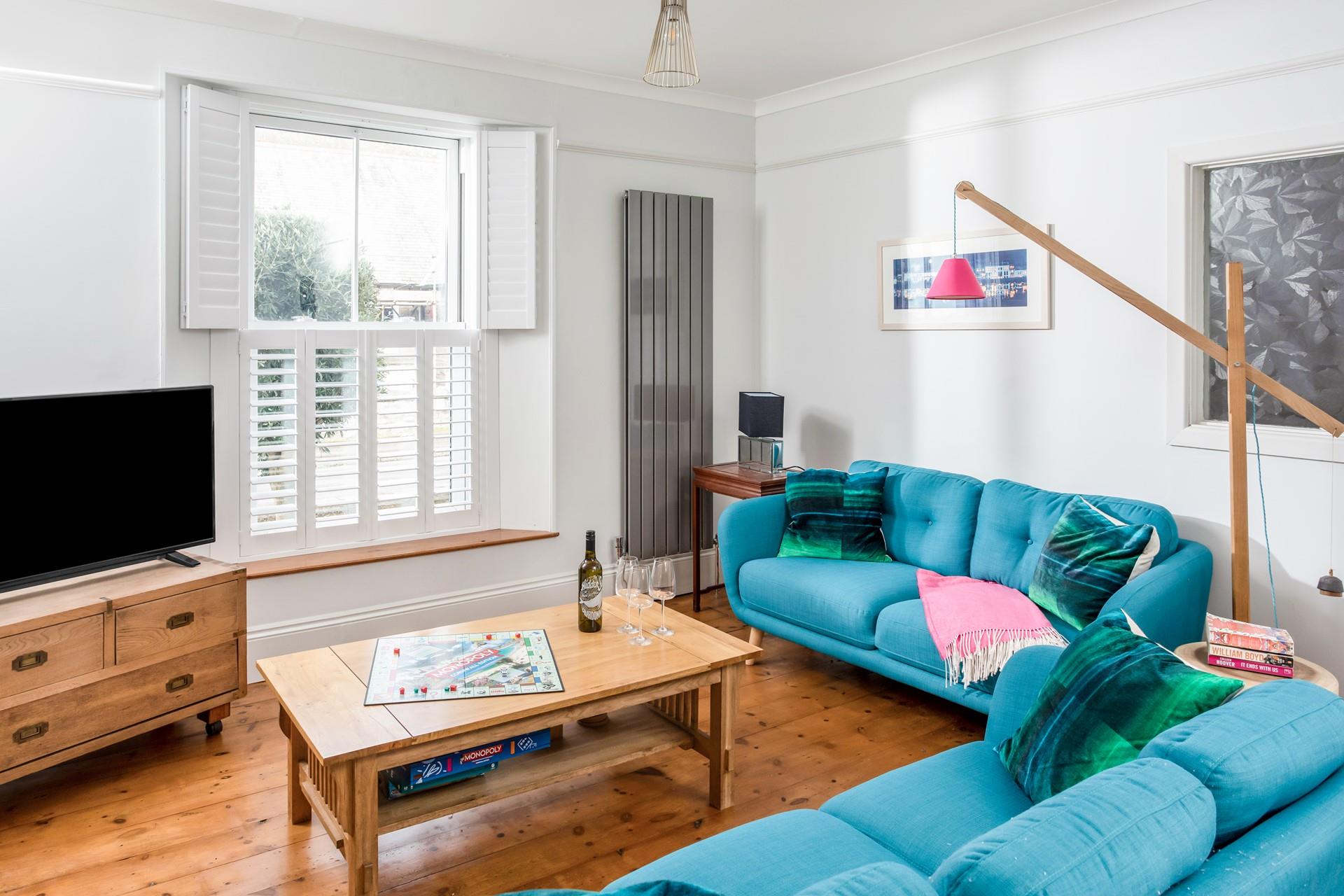 The bright blue sofas add a pop of colour to the stylish open plan living space.