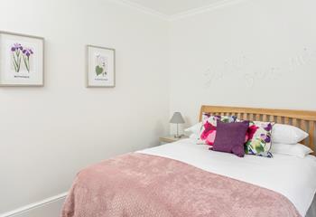 Bright cushions create a cheerful bedroom.