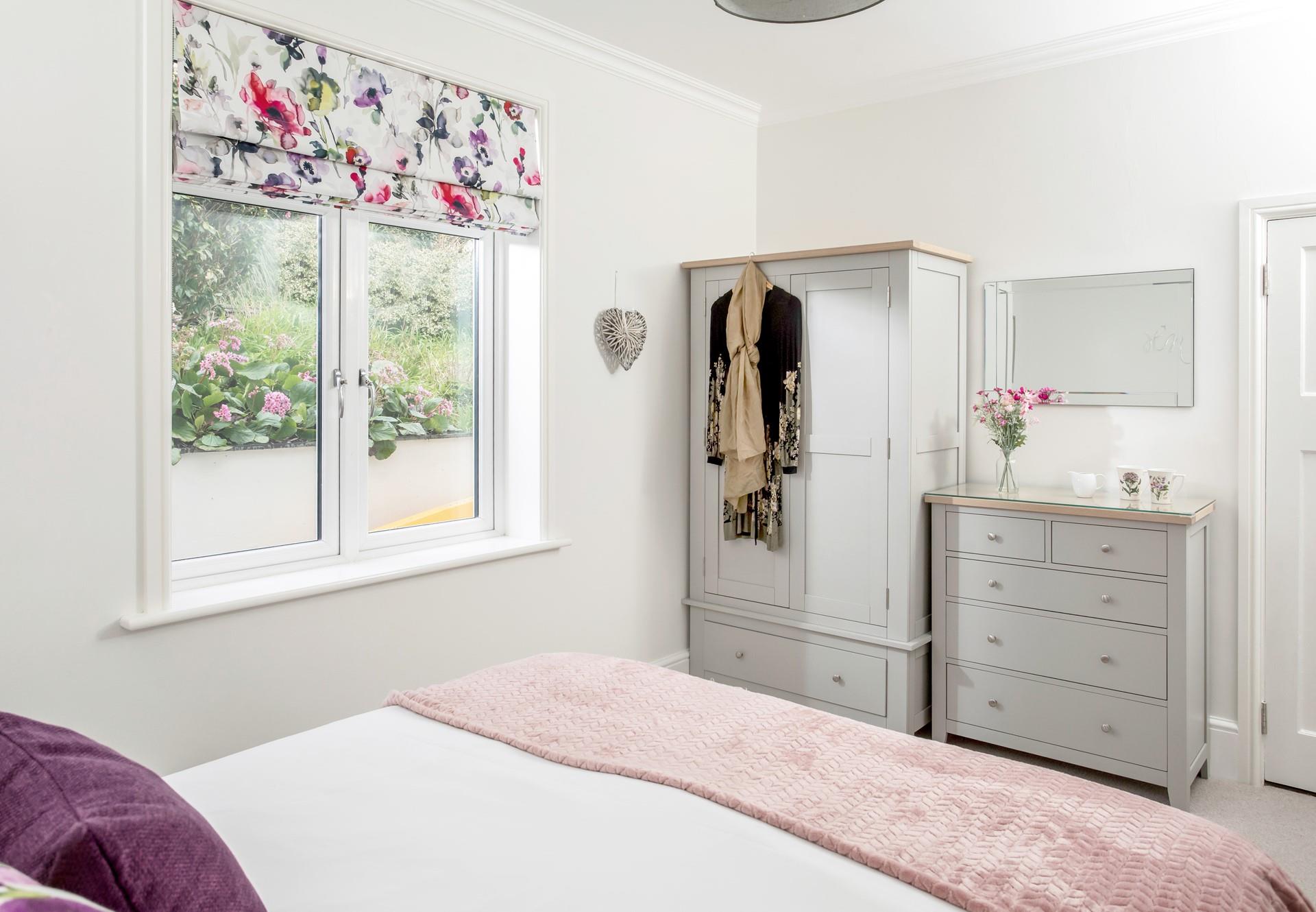 Open the blinds to let the sunshine into the bedroom.