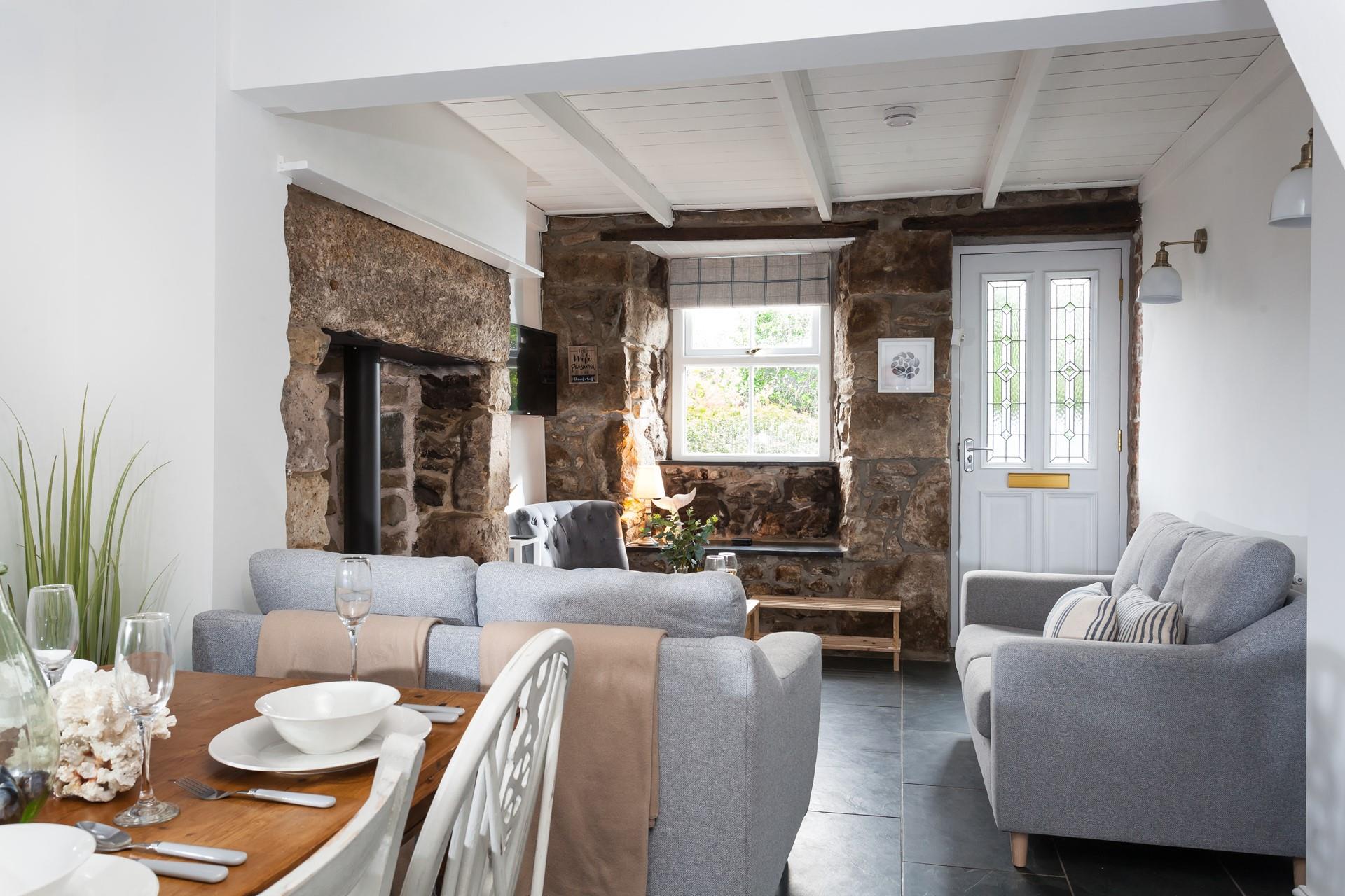 The open plan living area is cosy and full of cottage charm, perfect for spending quality time together.