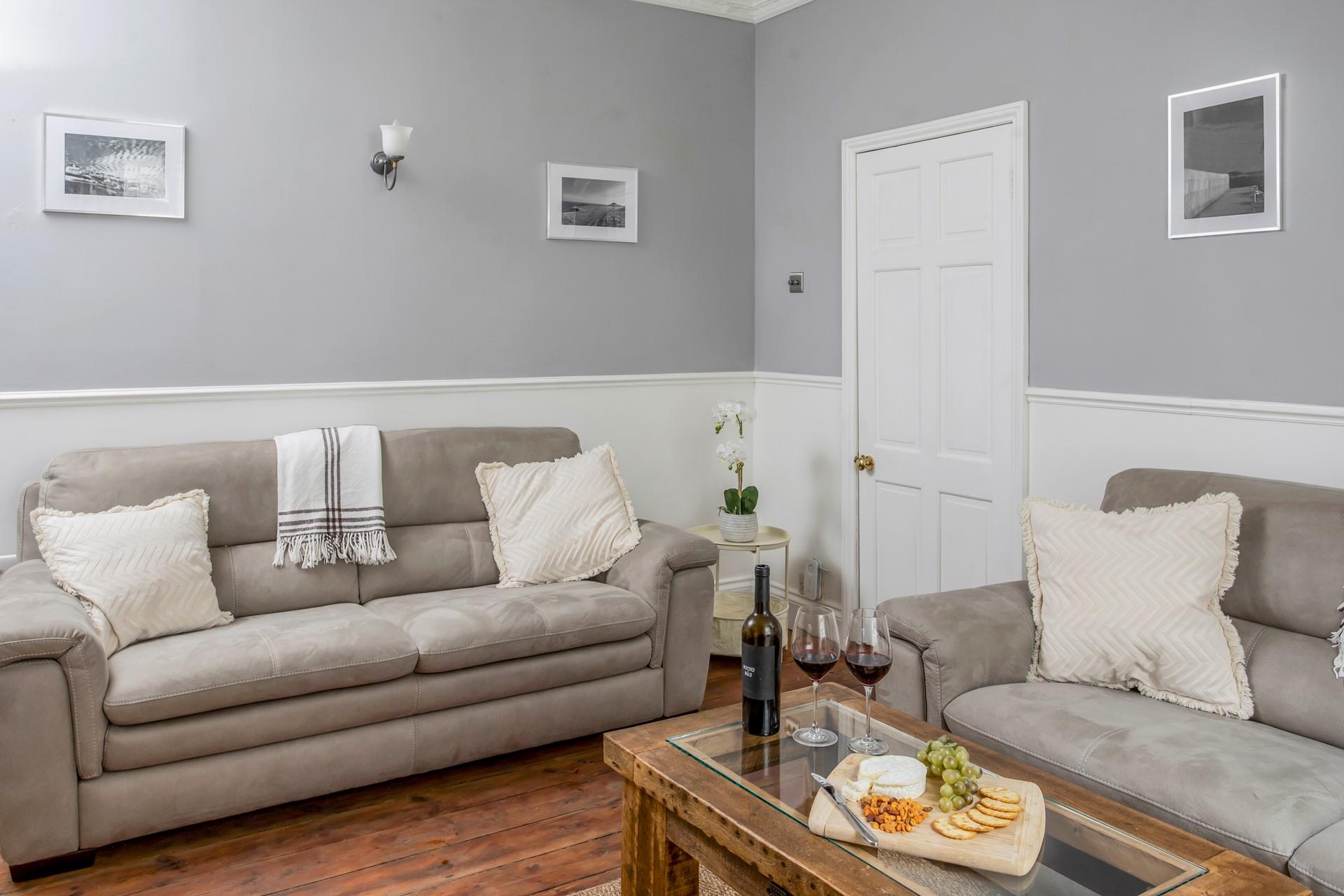 The cosy sitting room provides the ideal space to relax after a day walking the coast path.