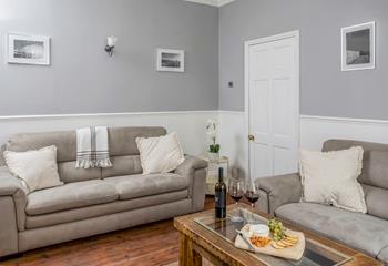 The cosy sitting room provides the ideal space to relax after a day walking the coast path.