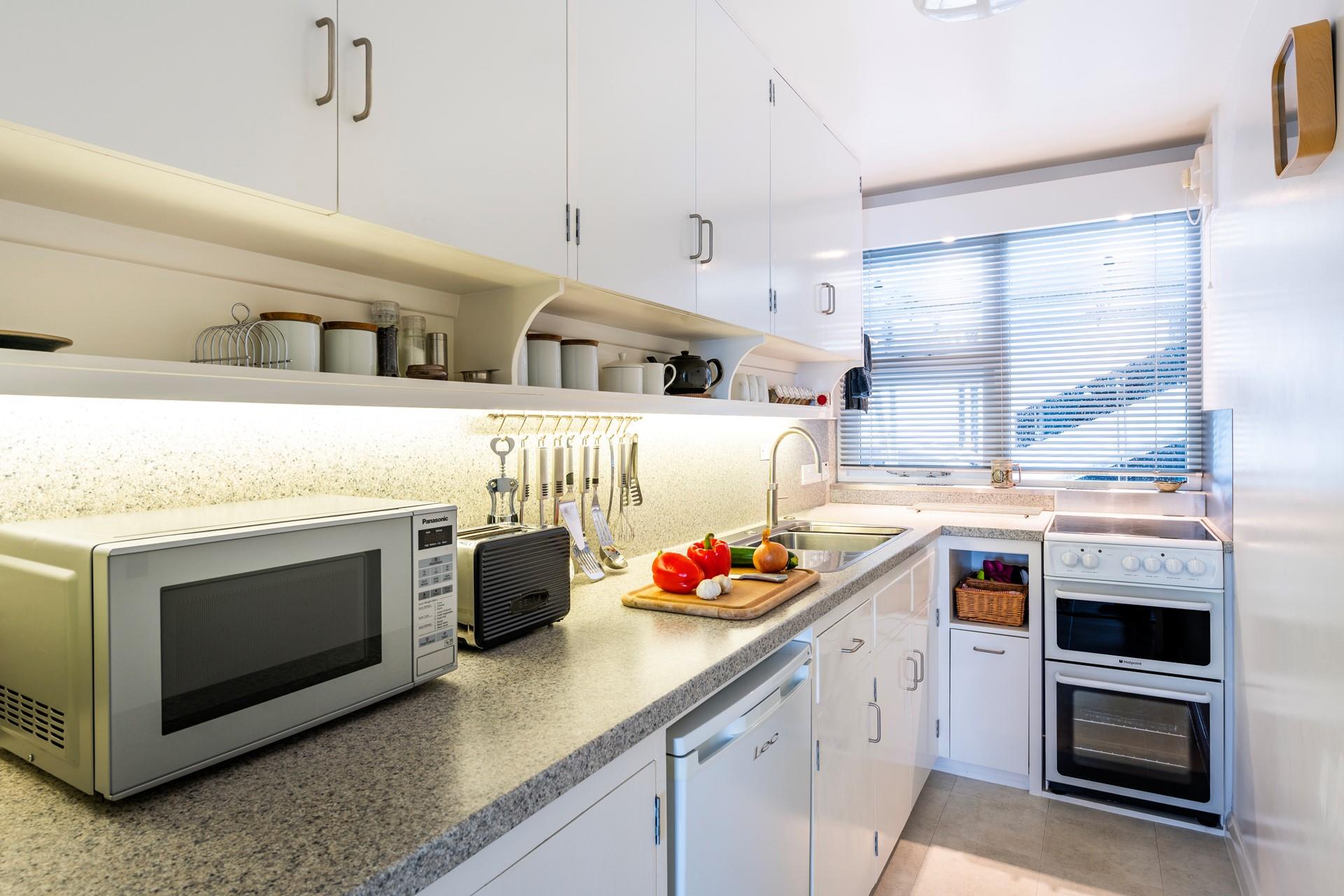 The kitchen is fully equipped to prepare and cook tasty meals.