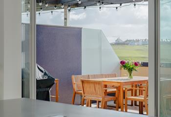 Step from the kitchen into the terrace with views across the golf course.