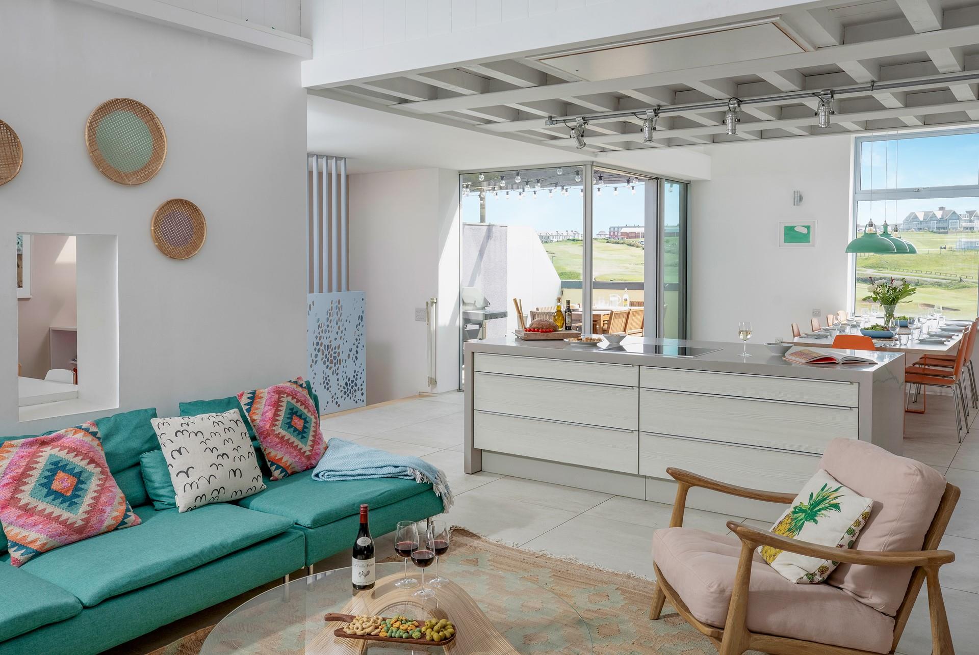 Quirky artwork and bright furnishings adorn the living area walls.