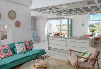 Quirky artwork and bright furnishings adorn the living area walls.