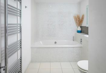 Slip into a rejuvenating bubble bath after a day on the beach.