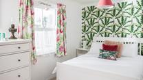 The bedroom has bright decor and is a relaxing base to come back to each day.