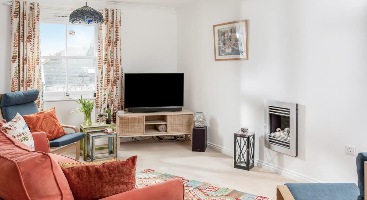 The cosy sitting room is perfect for nights in with a movie on the TV.