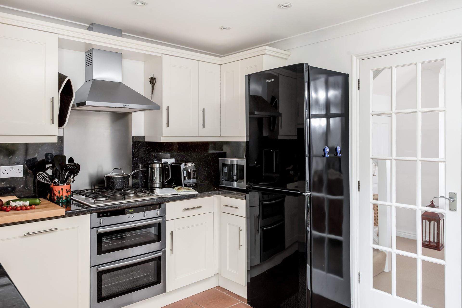 The well-equipped kitchen provides ample space to cook tasty meals.