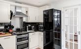 The well-equipped kitchen provides ample space to cook tasty meals. - Thumbnail Image