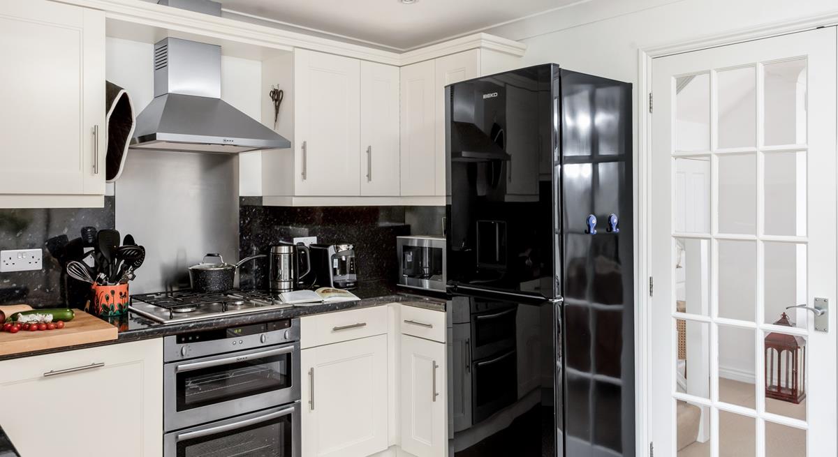 The well-equipped kitchen provides ample space to cook tasty meals.