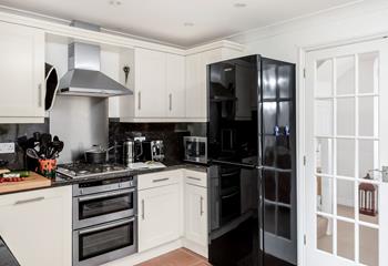 The well-equipped kitchen provides ample space to cook tasty meals.