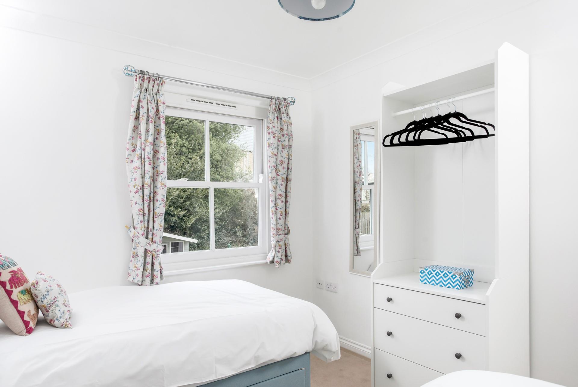 Open the curtains and check the weather for the day.