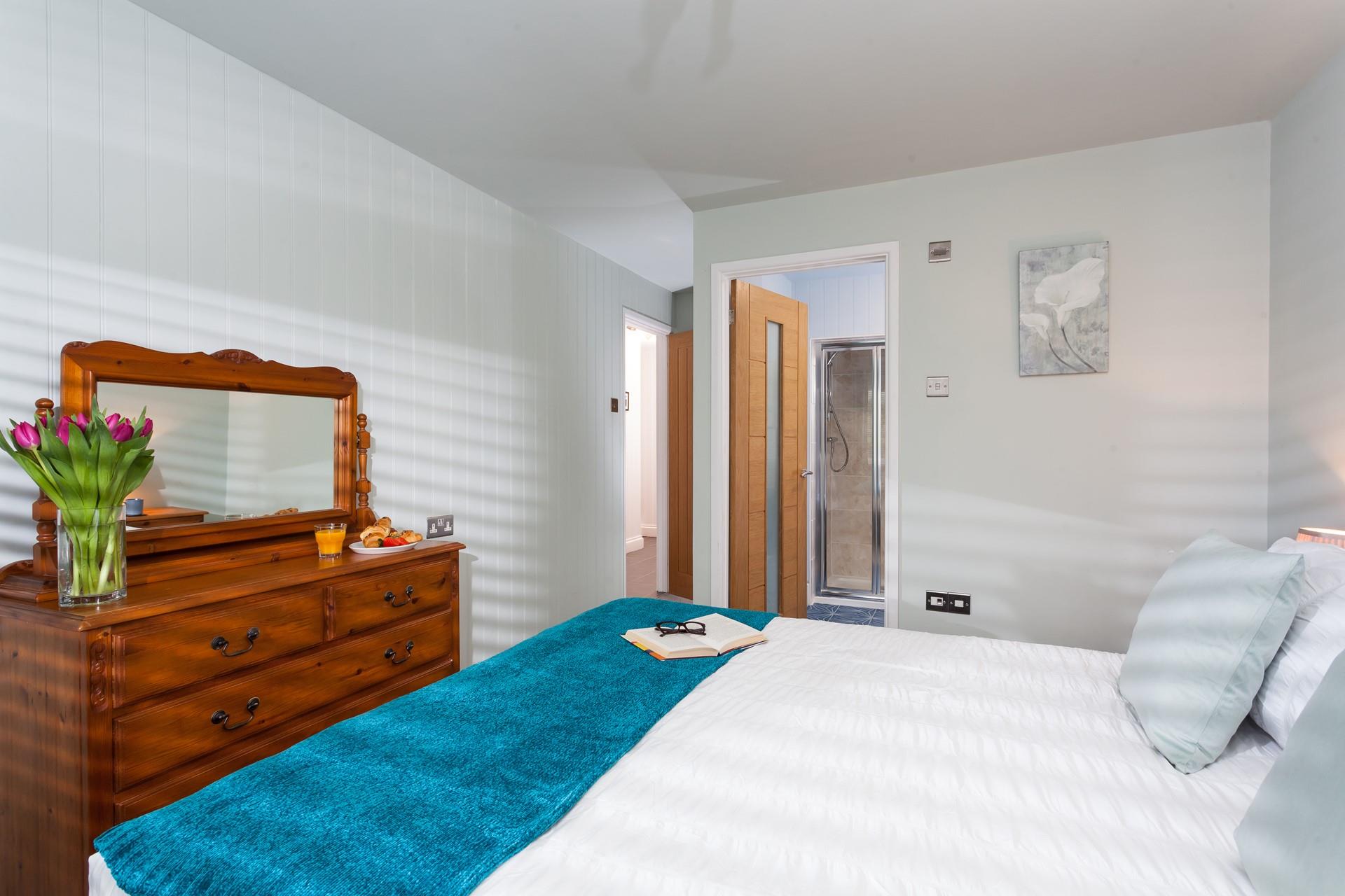 Bedroom 2 has a luxurious king size bed and an en suite to get ready for the day.