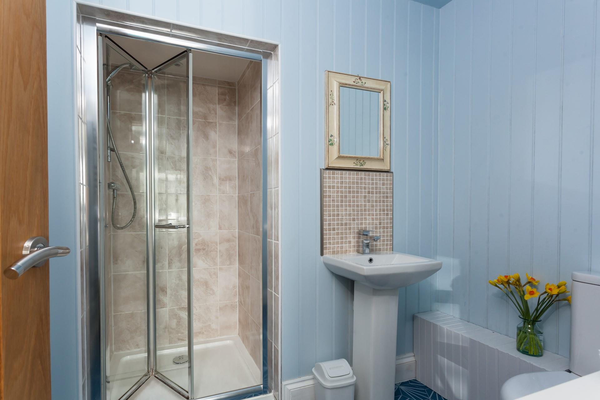 Shower off sandy toes from beach days in the en suite.