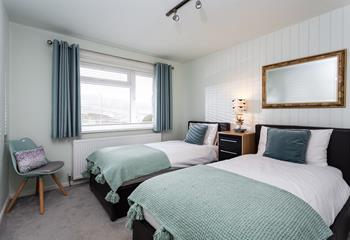 The twin room is decorated with a stylish blue and green colour scheme.