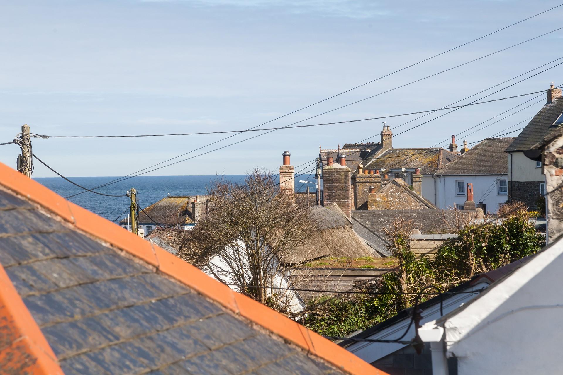 Enjoy sea views over the Cornish cottage rooftops.