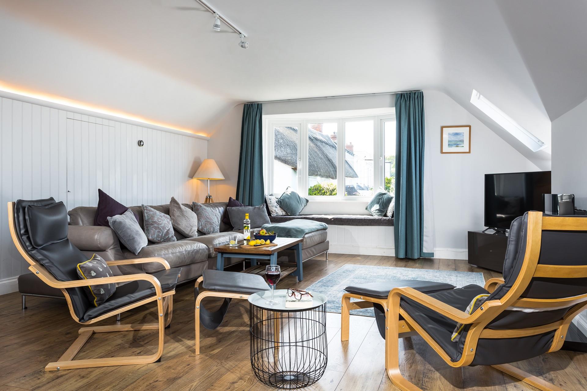 Unwind in the spacious living area after a day walking the nearby coast path.