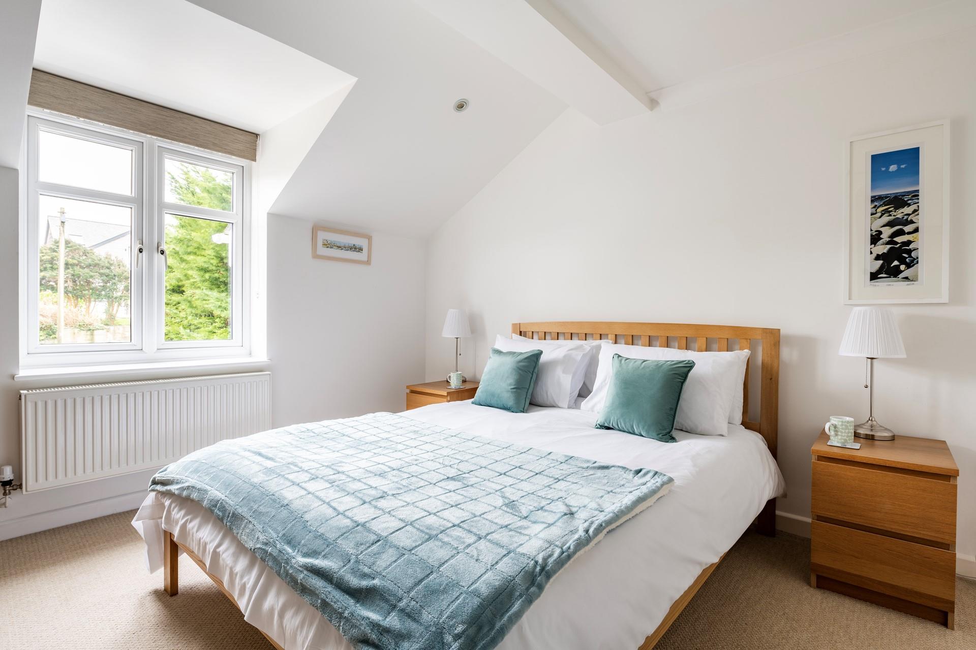 The spacious king size bed offers a blissful night's sleep.