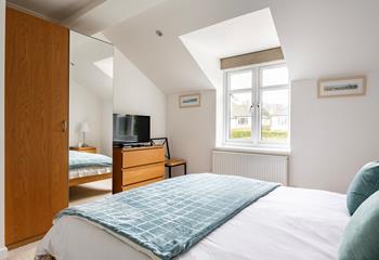 The bedroom has plenty of storage space and a cosy king size bed.