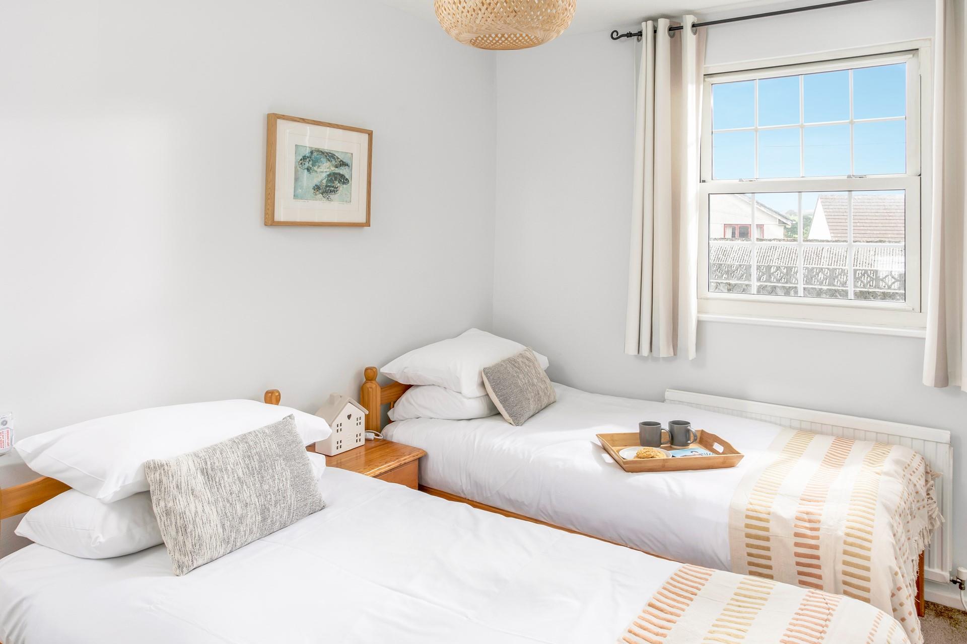 The sunny bedroom is light and bright with simple finishings.