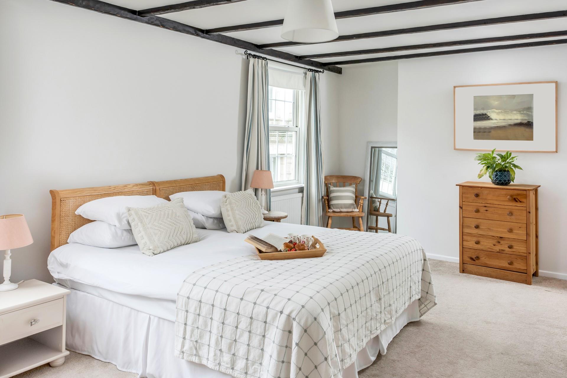 A serene bedroom, perfect for a good night's sleep after walking the coast path or exploring the local beaches.