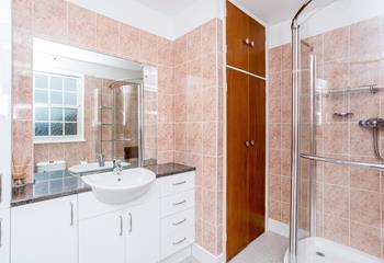 A spacious family bathroom with walk-in shower and deep sink.