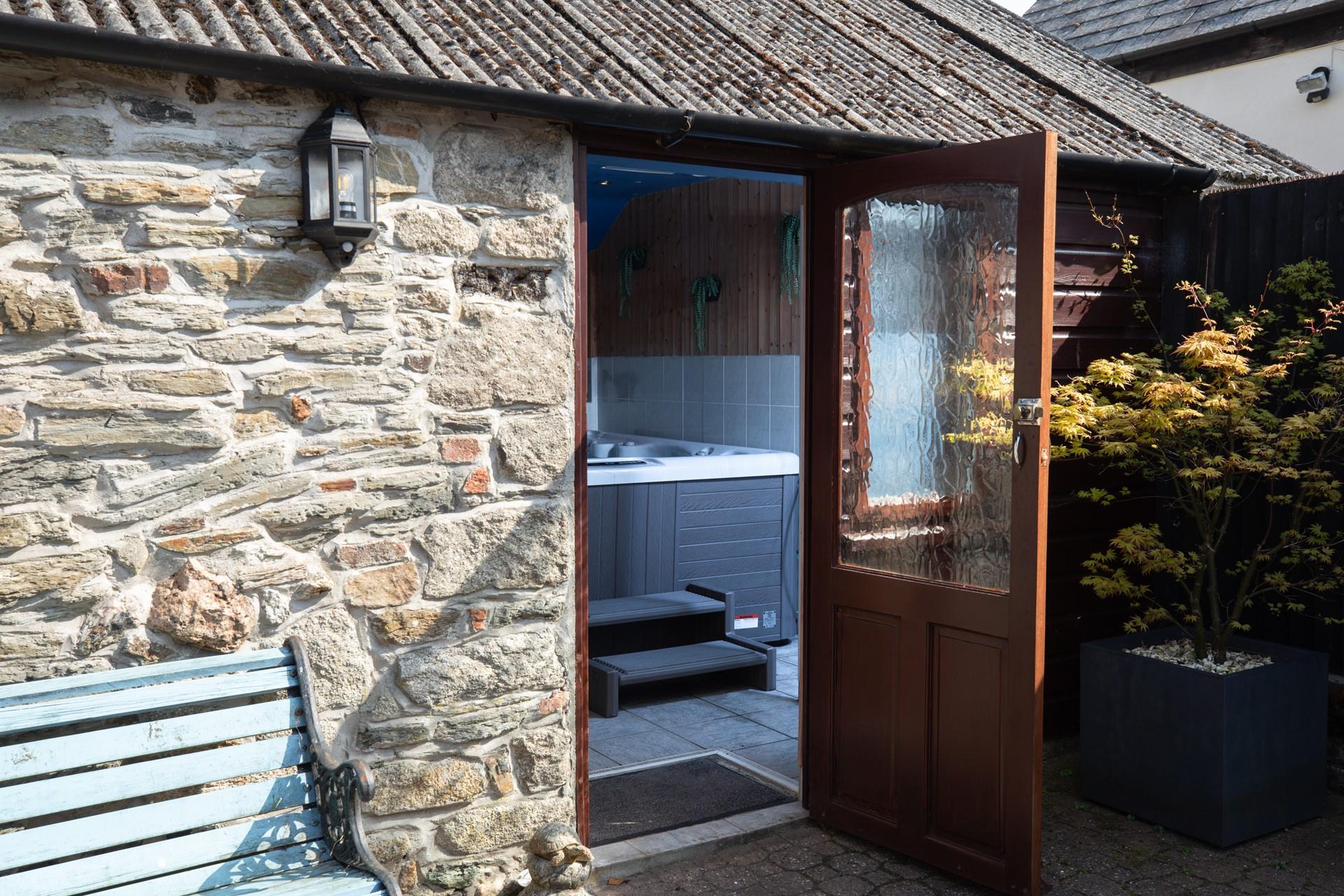 Tucked away, the inviting hot tub is a real treat.