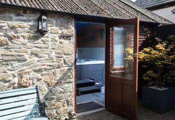 Tucked away, the inviting hot tub is a real treat.