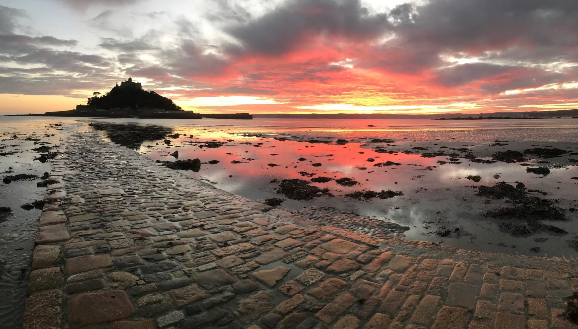 Watch a beautiful sunrise over St Michael's Mount to start the day.