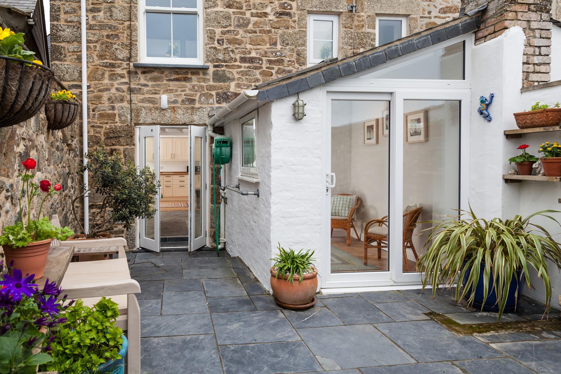 The patio has blooming plants in the patio area.