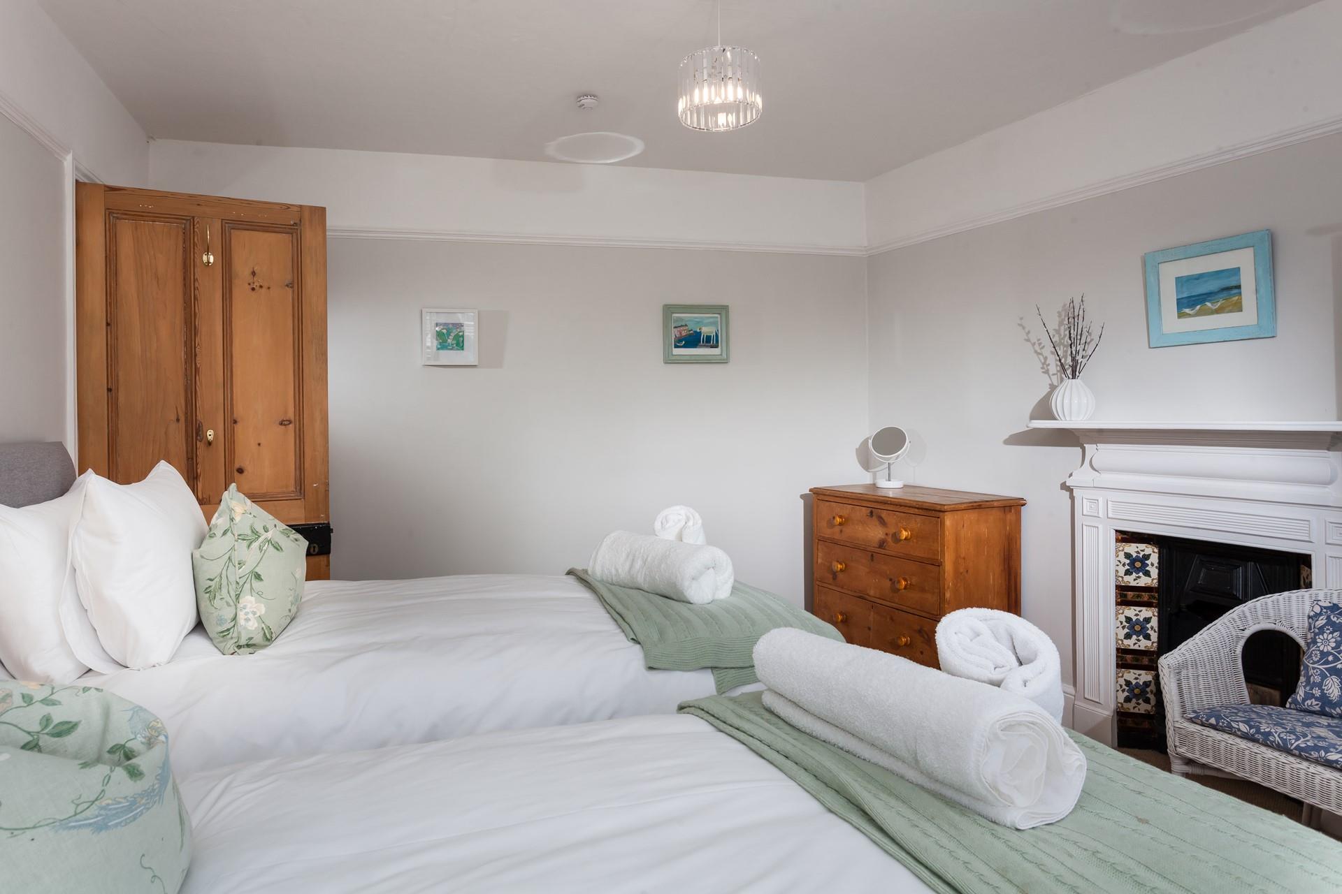 Bedroom 2 has pastel tones making for a relaxing space to unwind.