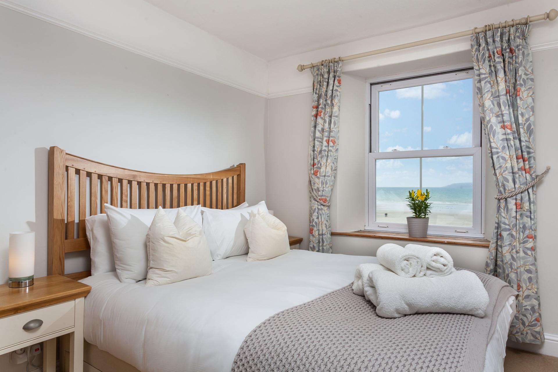 Open the curtains to reveal stunning sea views while you relax in bed.
