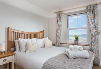 Open the curtains to reveal stunning sea views while you relax in bed.