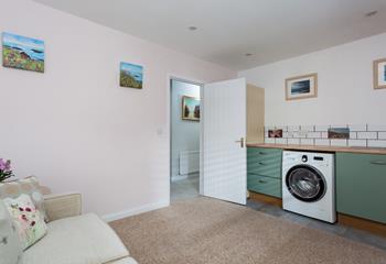 The utility room has a washing machine and a sofa.