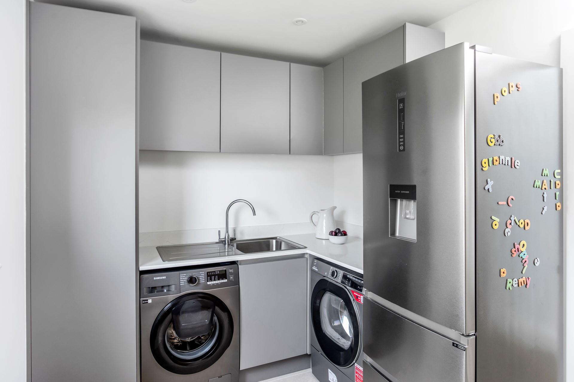 The utility room has a washing machine, tumble dryer and fridge freezer.