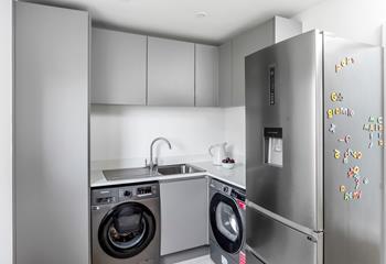The utility room has a washing machine, tumble dryer and fridge freezer.