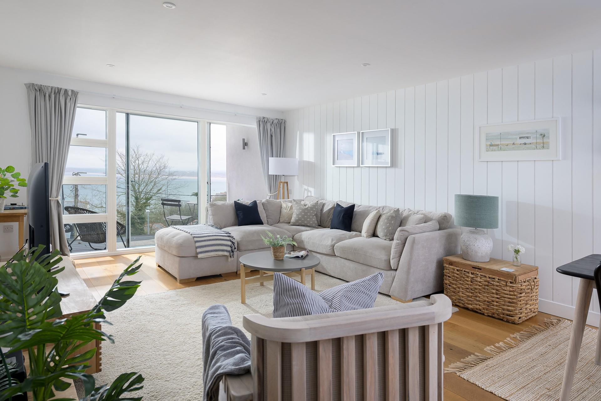 The sitting room is stylish and filled with light, perfect for spending relaxing evenings in.